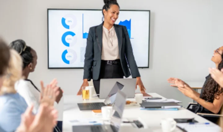 Trainerin leitet ISMS-Schulung vor Auditoren und Automotive-Fachpublikum im Besprechungsraum als Symbol für Informationssicherheits-Trainings in der Automobilindustrie.